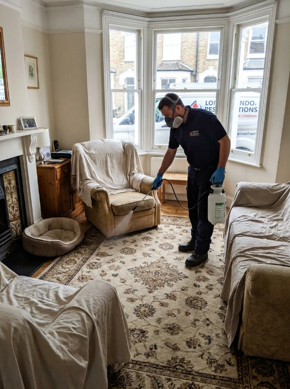 London pest control technician inspecting a kitchen